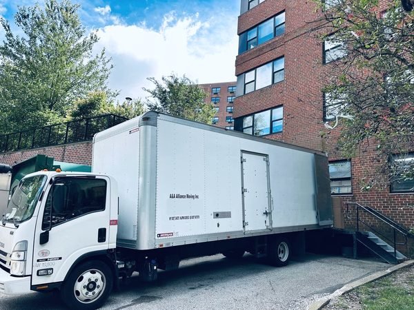 Our box truck parked by red-brick apartment buildings